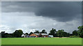 SJ6358 : Cheshire pasture, converted barns and heavy clouds by Roger  D Kidd
