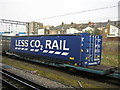 Freight train passing Willesden Junction: Tesco "Less CO2 Rail" container