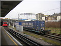 TQ2182 : Willesden Junction: freight train passing and tube approaching by Christopher Hilton
