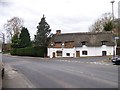 A thatched cottage at the corner of Preston Hill and the A257