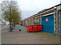 SS5099 : Red wheelie bins and blue globes outside Llanelli railway station by Jaggery