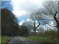 Road junction and woodland near Langstone Manor