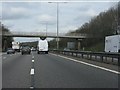 SP7456 : M1 motorway - footbridge north of Collingtree by Peter Whatley