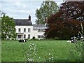 Dairy cows grazing in front of Allostock Hall