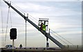 TA0225 : Workmen ascending the Humber Bridge cable by Steve Daniels