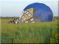 TL3995 : Hot air balloon in a grass field near March by Richard Humphrey
