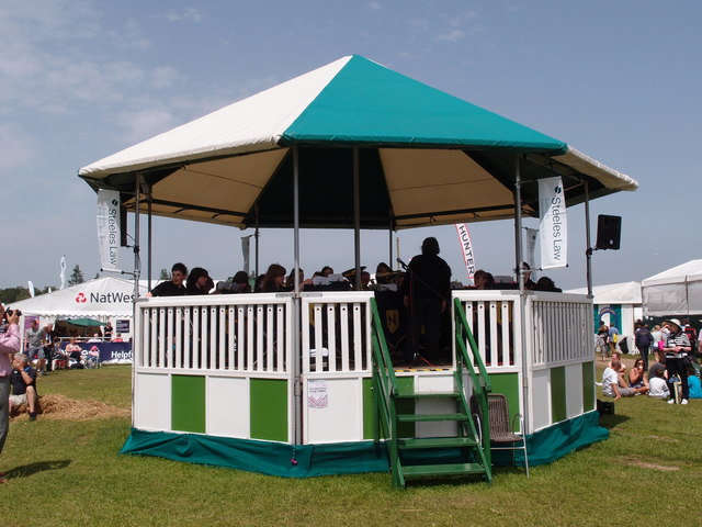 Bandstand at the Royal Norfolk Showground Lively music played by many school bands and orchestras are a feature of this popular form of entertainment.
A Norfolk show has been held since 1847 it gained its Royal prefix in 1908. From 1953 until 1962 the show moved round the county being held on suitable parkland sites. The present site at Costessey covers 375 acres. New exhibition hall and reception areas are the latest additions to the multipurpose site. Average attendance for the two day show hovers around the 100,000 mark.