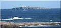 NU2135 : Telephoto of Inner Farne island and lighthouse by Mike at Seahouses