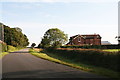 Brackenborough Wood and a farm cottage