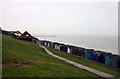 Beach huts at the bottom of the grass slope