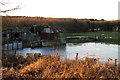 Dilapidated farm buildings and icy waterlogged field