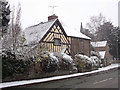 Cottage in the snow on the corner of Church Lane