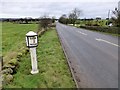 Milepost beside the A523