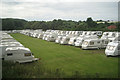 Caravan parking in a field by the railway