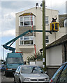 Painting a house from a hydraulic platform