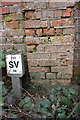 Benchmark on roadside farm building wall, Foxcombe Road