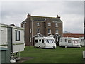 A  Very  Big  House  on  a  Caravan  Park