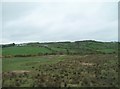 View across farmland towards Leode Quarry