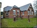 TF3427 : Statues outside the old school in Saracen's Head by Richard Humphrey