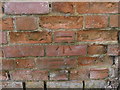 Benchmark on a brick wall at Rolfes Farm