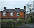 Brick-built cottage in Eardiston with an old advertisement