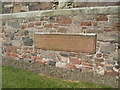 A stone built in to the east wall of Morebattle Church