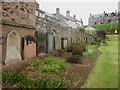 Headstones against the wall of former burial ground Eyemouth