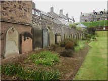 NT9464 : Headstones against the wall of former burial ground Eyemouth by Graham Robson