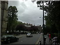 View of a house with neat rows of chimney pots on Spensley Walk from Stoke Newington Church Street