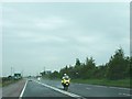 J1977 : PSNI motorcyclists on the A26 south of the Belfast International Airport by Eric Jones