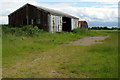 Battered farm sheds by Folly Farm