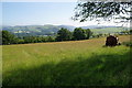 Muck-spreader in a fallow field near Tan-y-graig