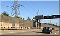 Timber and glass noise barrier, M25 northwest of Byfleet