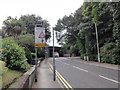 Defective road sign and railway bridge