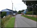 Road passing between farm buildings, Little Brechin