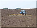 Rolling a newly-ploughed field