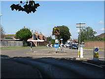 SZ8998 : Pagham village sign in middle of roundabout by Dave Spicer