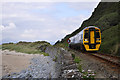 SH5729 : Train beneath Harlech Cliff by Stuart Wilding