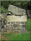 NU2519 : Carved sign at entrance to Craster by Graham Robson