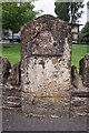 Old milestone in wall on NW side of High Street