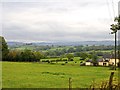 Looking over Brook House Farm from Toad Hall over Little Wood Cottages towards Leek and the Roaches in the far distance