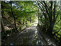 The Kirklees Way approaching the yard at the foot of the Butterley Reservoir spillway