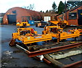 Yellow machinery inside a yard in Cinderford