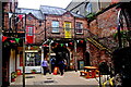 Derry - Courtyard with Archway  & Stairs up to Red & Yellow Doors in Craft Village