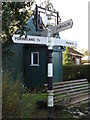 TG2504 : Roadsign, Arminghall Village sign & Hall by Geographer