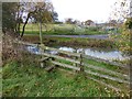 Stile and duckpond on St Oswald