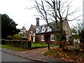 House with ornate  porch and chimney opposite Holy Trinity church, Heydon