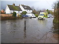 An ambulance drives through the flood at Wateringbury on Christmas Day