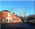 Gasholder, terraced row and railway bridge