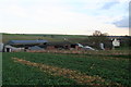 Grange Farm across a field of oilseed rape